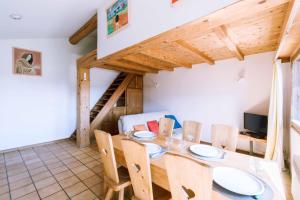 a dining room with a wooden table and chairs at Chalet cosy in Bourg-Saint-Maurice