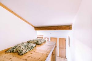 a bedroom with two pillows on a wooden floor at Chalet cosy in Bourg-Saint-Maurice