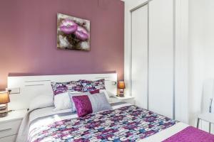 a bedroom with purple walls and a bed with purple pillows at Magnolia A - Solo Familias in Conil de la Frontera +20 photos