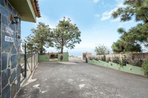 an empty road with a fence and a tree at Finca Aramai in Adeje