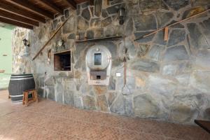 a stone wall with a stone oven in a room at Finca Aramai in Adeje