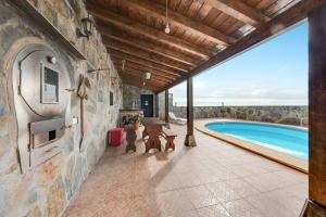 an indoor patio of a house with a swimming pool at Finca Aramai in Adeje