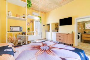 a living room with a large bed and a tv at Casa donna Sofia in Specchia