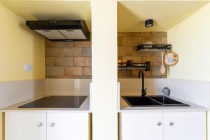 a kitchen with a sink and a stove at Casa donna Sofia in Specchia