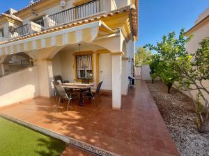 a patio with a table and chairs in front of a house at Relax Inn in Pilar de la Horadada