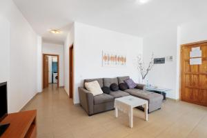 a living room with a couch and a table at Alcamar in Alcalá