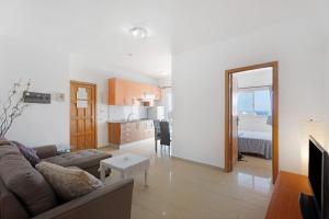 a living room with a couch and a dining room at Alcamar in Alcalá