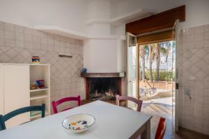 a kitchen with a table and a fireplace at Casa Ginevra Salento in San Cassiano