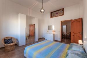 a bedroom with a large bed in a room at Casa Ginevra Salento in San Cassiano