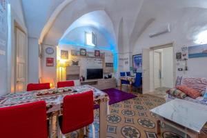 a living room with a table and red chairs at Dimora storica monteroni di lecce in Monteroni di Lecce