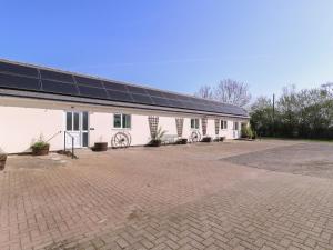 a building with solar panels on the side of it at The Turbles - Swallows Nest in Castlemorton