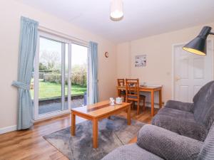 a living room with a couch and a table at The Turbles - Swallows Nest in Castlemorton