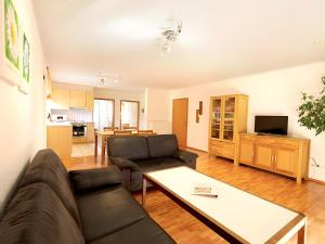 a living room with a couch and a table at Ferienhof Bosch in Börslingen