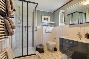 a bathroom with a shower and a toilet and a sink at Backhaus in Groß Wokern +26 photos