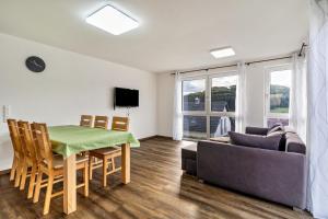 a living room with a table and a couch at Ferienwohnungen Kapellenblick in Biederbach Baden-Württemberg