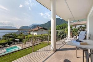 a balcony with a view of the mountains at Eco del Garda Apartments in Tenno