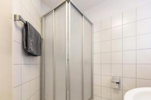 a shower with a glass door in a bathroom at Ferienwohnung Rheinblick in Küssaberg