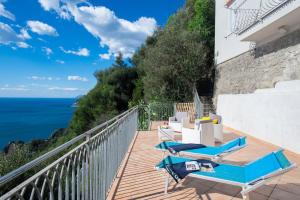 a balcony with chairs and a view of the ocean at Villa Domus Augusto in Conca dei Marini