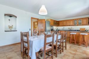 a kitchen with a white table and chairs in a room at Can Cancus in Capdepera