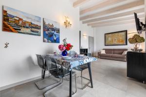 a dining room with a table with flowers on it at Eco del Garda Apartments in Tenno