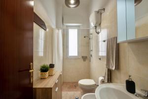 a bathroom with a toilet and a sink and a shower at Casa Vacanze Kalocéri in Torre dell'Orso +17 photos