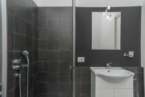 a bathroom with a sink and a shower with a mirror at Villa Marisa in Budoni