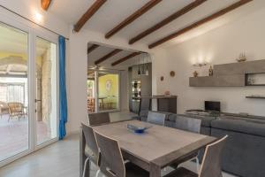 a dining room with a table and a couch at Villa Marisa in Budoni +22 photos