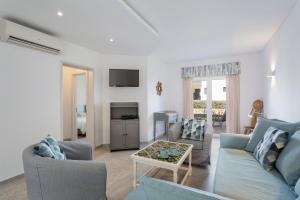 a living room with a couch and a table at Villa Isabel in Vale do Lobo