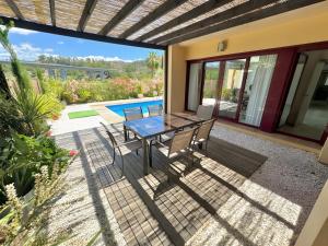a patio with a table and chairs and a pool at Villa with Private Pool in Estepona
