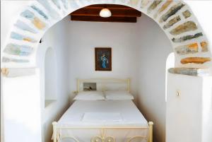 a bedroom with a bed in a white room at Zeus House in Naxos Chora