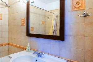a bathroom with a sink and a mirror at Zeus House in Naxos Chora