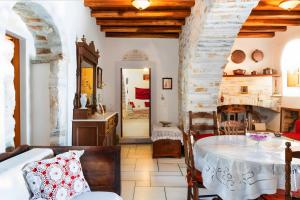 a living room with a table and a fireplace at Zeus House in Naxos Chora +37 photos
