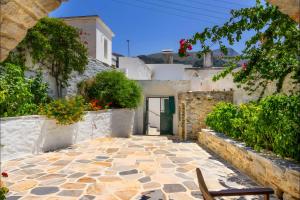 a stone walkway in front of a white building at Zeus House in Naxos Chora