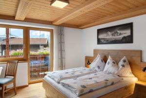 a bedroom with a bed and a large window at Ferienwohnung Haus Brugger in Uttendorf