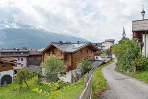 a small village with a mountain in the background at Ferienwohnung Haus Brugger in Uttendorf