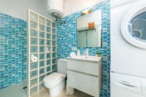 a bathroom with a toilet and a sink and a mirror at Es Claper in Cala Ratjada +23 photos