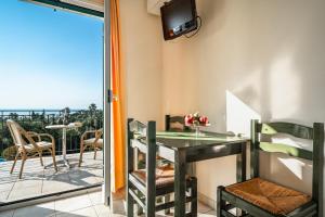a room with a balcony with a table and chairs at Anemona apartment 2 in Kefallonia