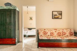a living room with a couch and a bedroom at Anemona apartment 2 in Kefallonia