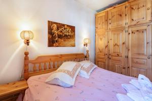 a bedroom with a bed with two pillows at Ciasa Apelli in Pozza di Fassa