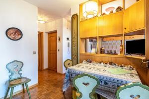 a dining room with a table and chairs at Ciasa Apelli in Pozza di Fassa +21 photos