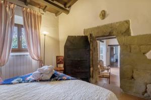 a teddy bear sitting on a bed in a bedroom at Universal Harmony - Nibbio in Dicomano +20 photos