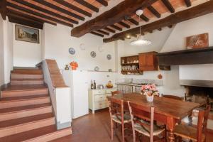 a kitchen and dining room with a wooden table at Universal Harmony - Nibbio in Dicomano