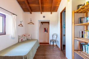 a bedroom with a bed and a book shelf at Finca Las Nuevas Casa Carmen in Alora