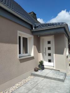 a house with a white door and a window at Ferienhaus Kirsch in Blankenhain