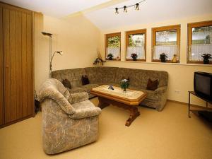 a living room with a couch and a coffee table at Haus Margot Armbruster in Bad Rippoldsau-Schapbach