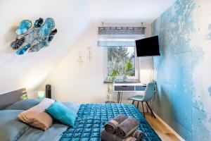 a bedroom with a bed and a desk and a window at Ferienhaus Kirsch in Blankenhain