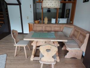 a wooden play house with a table and chairs at Haus Seidelbast in Siegsdorf