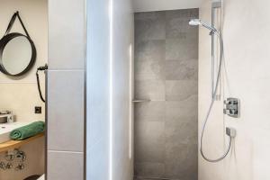 a shower with a glass door in a bathroom at Luisalle Top 4 in Auffach +19 photos