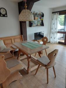a dining room with a wooden table and chairs at Haus Seidelbast in Siegsdorf +15 photos