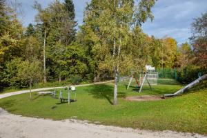 a park with a playground and a swing set at Haus Seidelbast in Siegsdorf